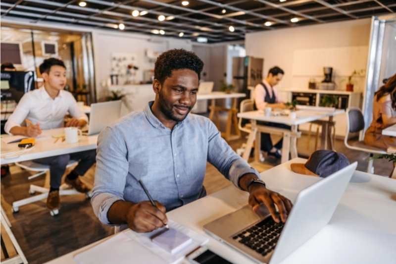 man working in apartment amenity coworking space