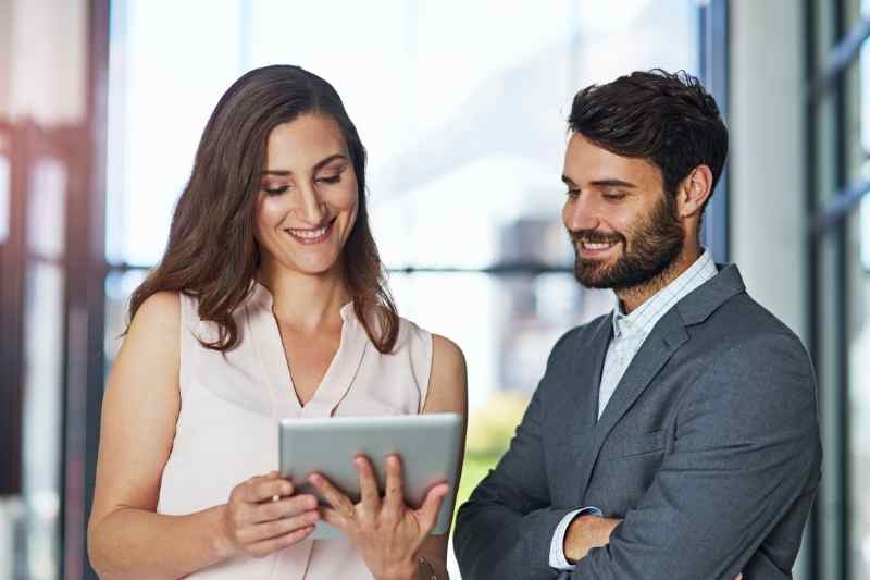 A chief smart building officer showing colleague reports on tablet