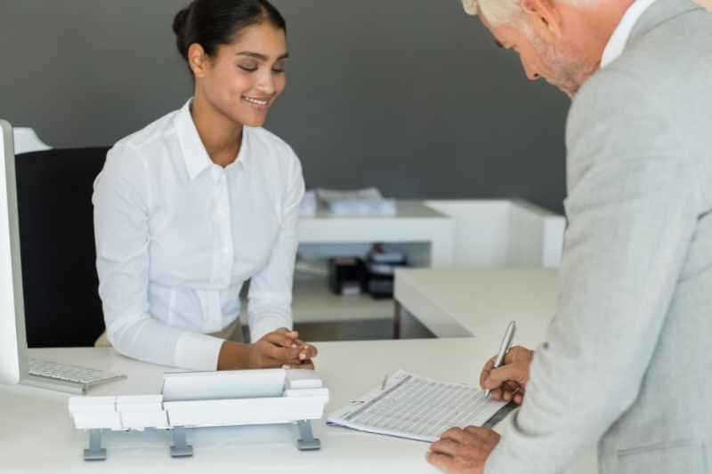 Office visitor using pen-and-paper method to sign in