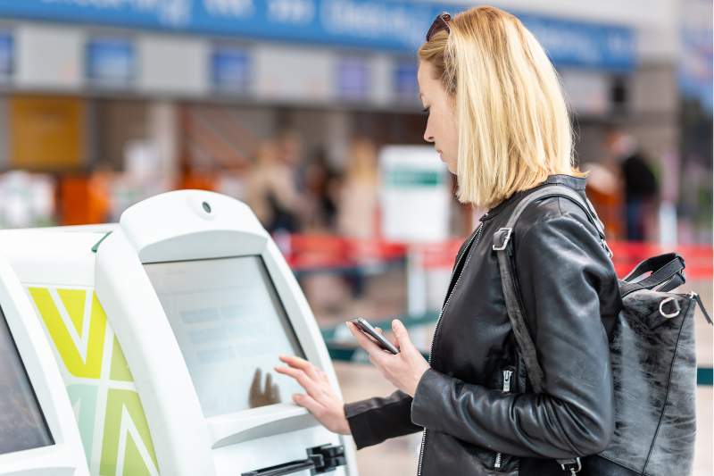 guest checking in with visitor management kiosk