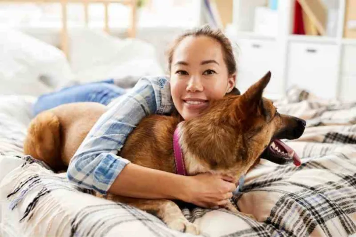 Resident with a pet dog in her apartment