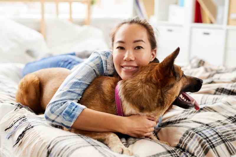 Resident with a pet dog in her apartment