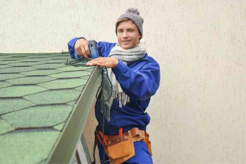 checking gutters for winter property management