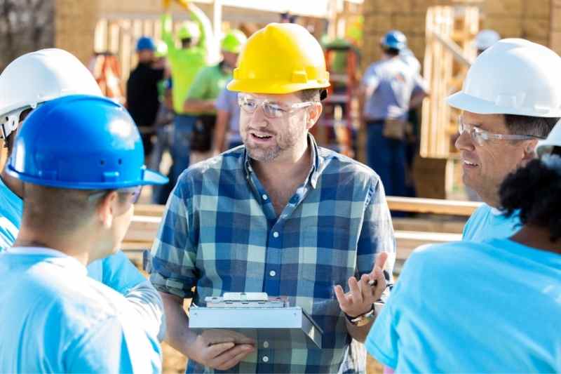 Construction manager communicating with workers