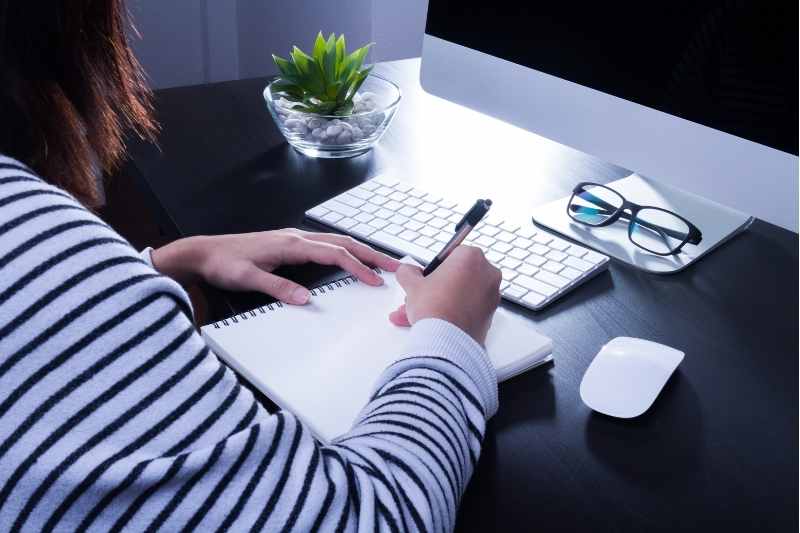 woman writing apartment newsletter