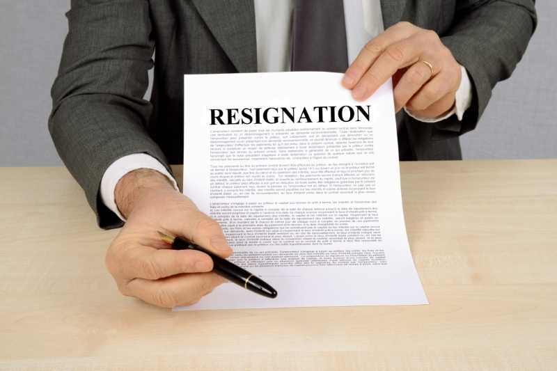 Employee handing over a resignation letter.