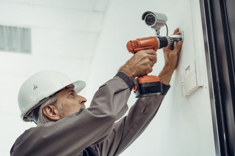 security system installer installing a camera