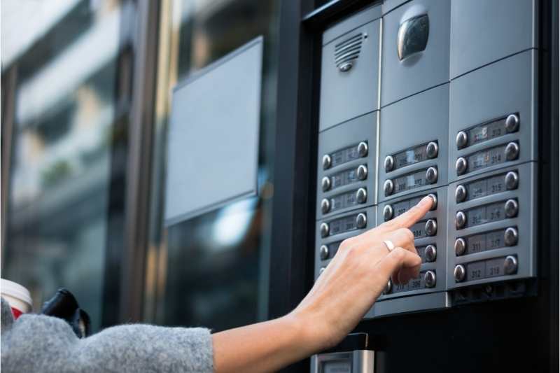 woman pressing button on IP door phone system