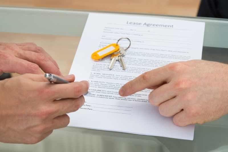 Apartment applicant signs a lease with their property manager.