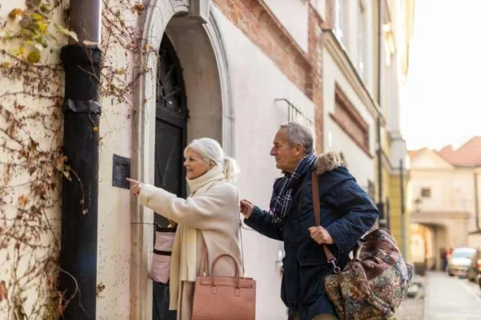 Guests speak to a resident using a doorbell camera with monitor.