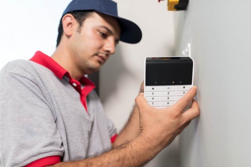 A hard at work access control system installer in Chicago