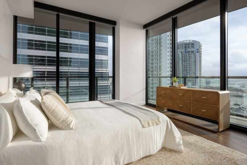 Inside the bedroom of a Heron Water Street Apartment unit with skyline views.