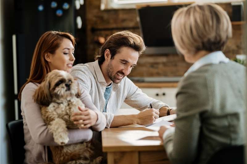A couple and their dog sign a lease thanks to multifamily leasing tips