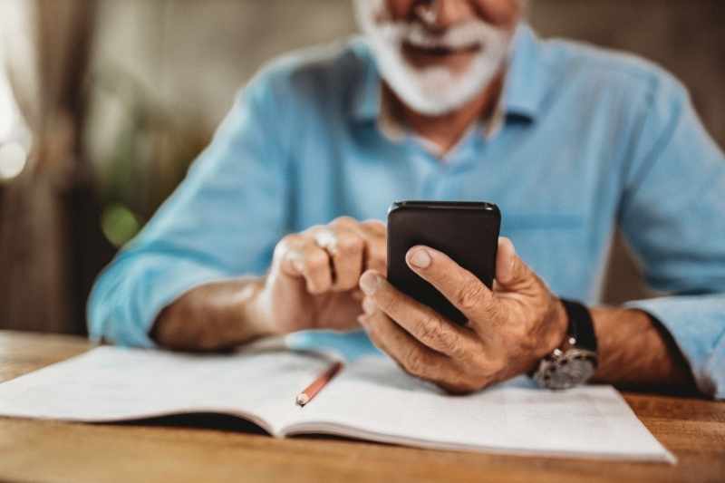 Resident uses their smartphone to access senior housing amenities