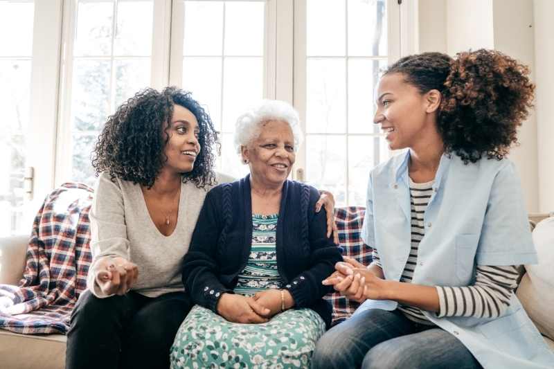 A senior resident chats with their loved ones about senior housing amenities.