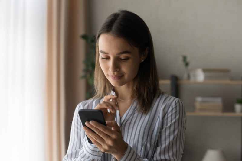 Resident browses an apartment community app on their smartphone.