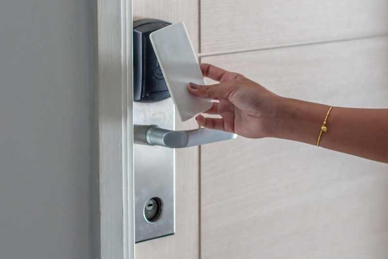 Tenant unlocks a key card door lock.