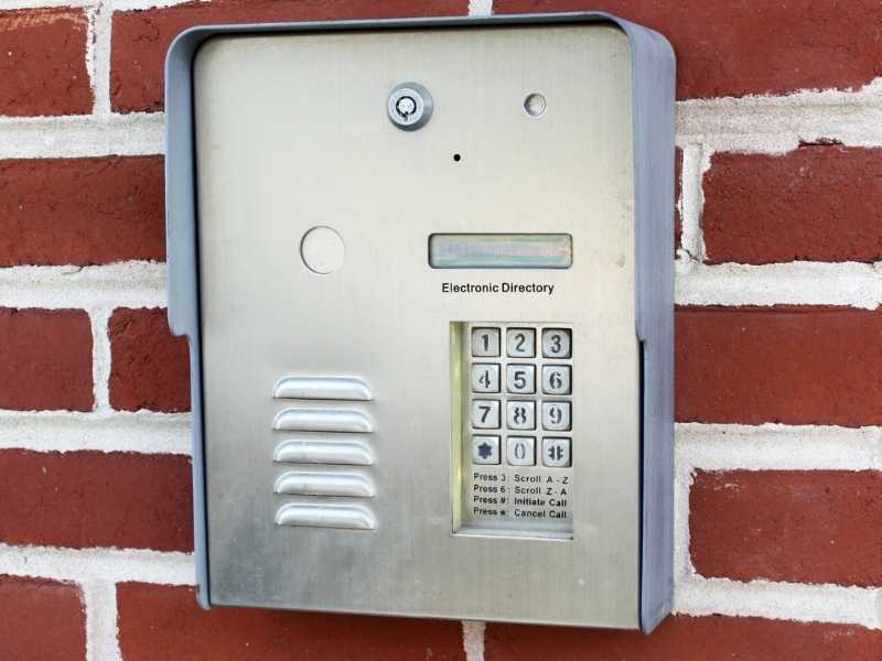 doorking telephone entry system installed on brick wall