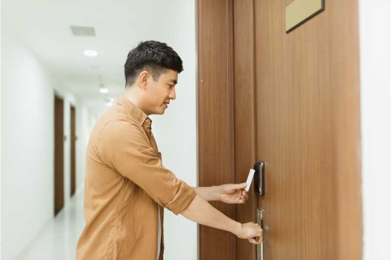 A resident uses a card reader door lock with ease.