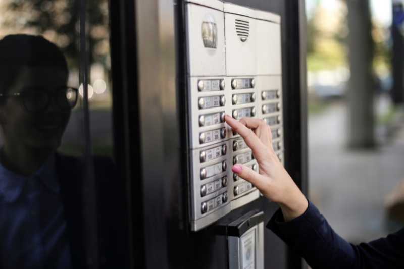 visitor using intercom call box