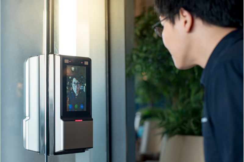 A biometric door lock scans a man's face