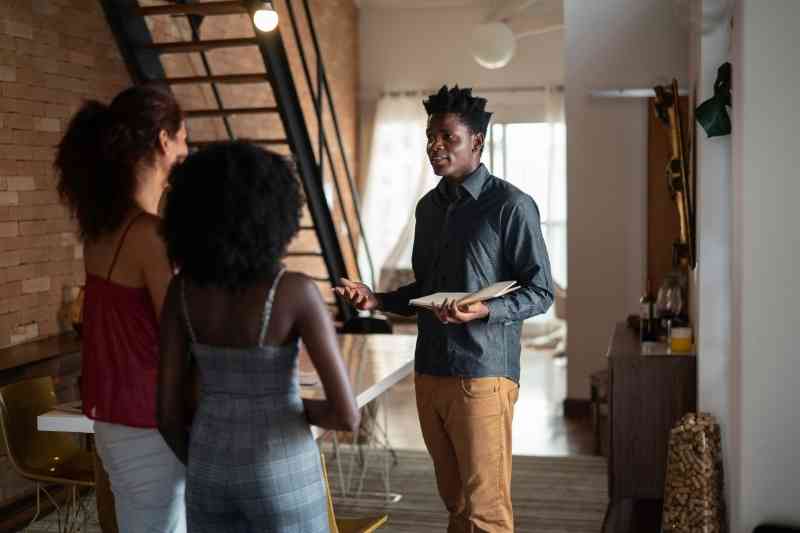 A property manager gives a tour to prospective residents.