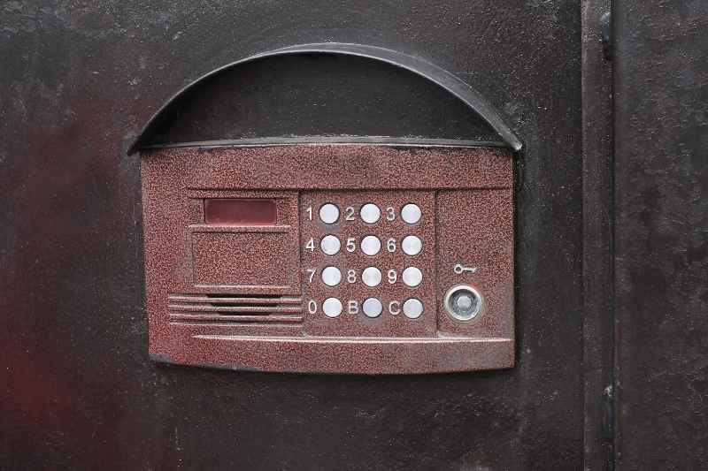 old intercom system on black metal wall