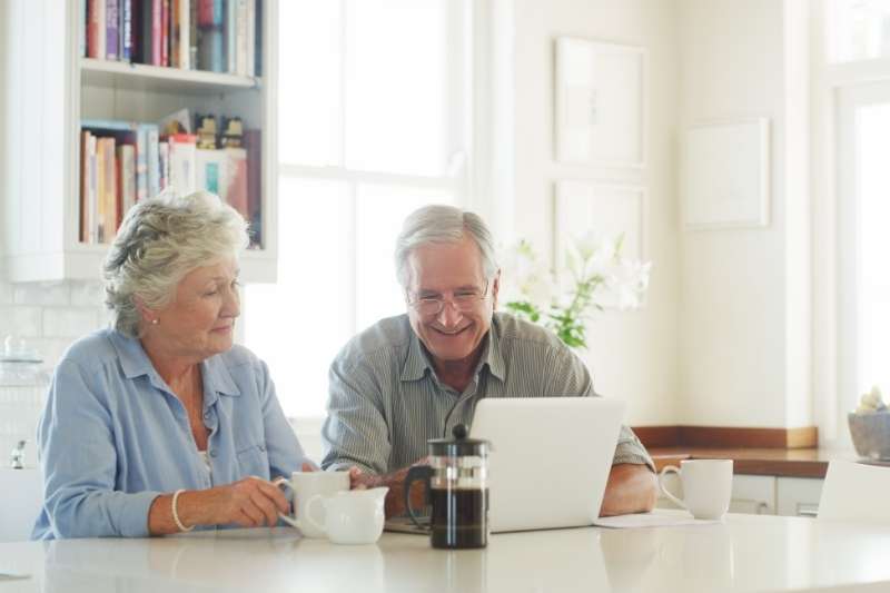 senior couple using laptop aging in place