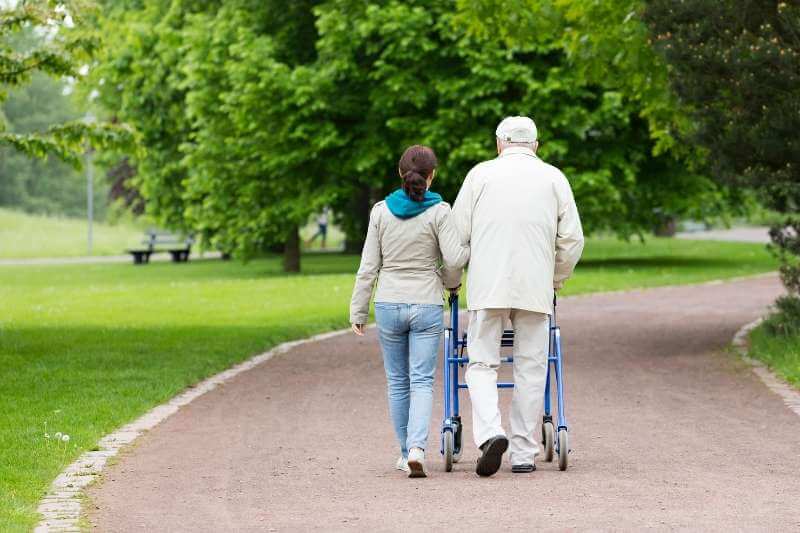 senior housing manager walks with a tenant