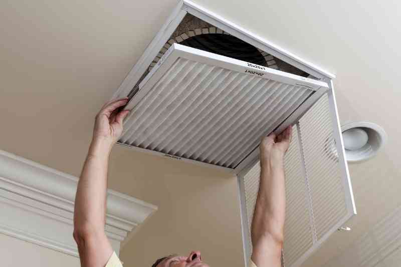 Installing a new HVAC filter.