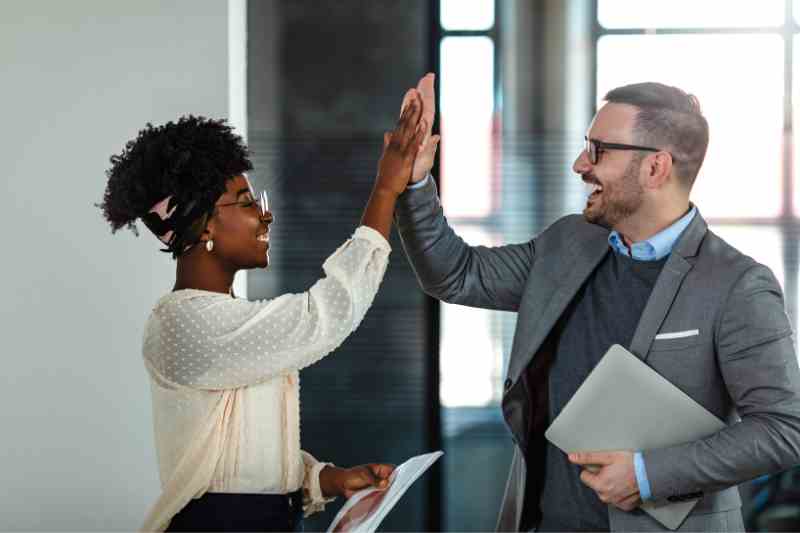 Resident high-fiving a property manager.