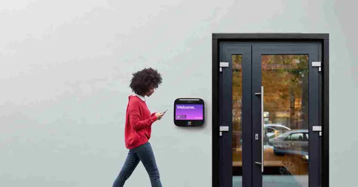 Resident approaches a front door fitted with the new ButterflyMX video intercom.