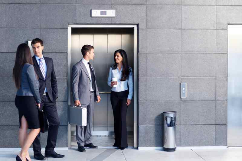 elevator companies people standing in an elevator