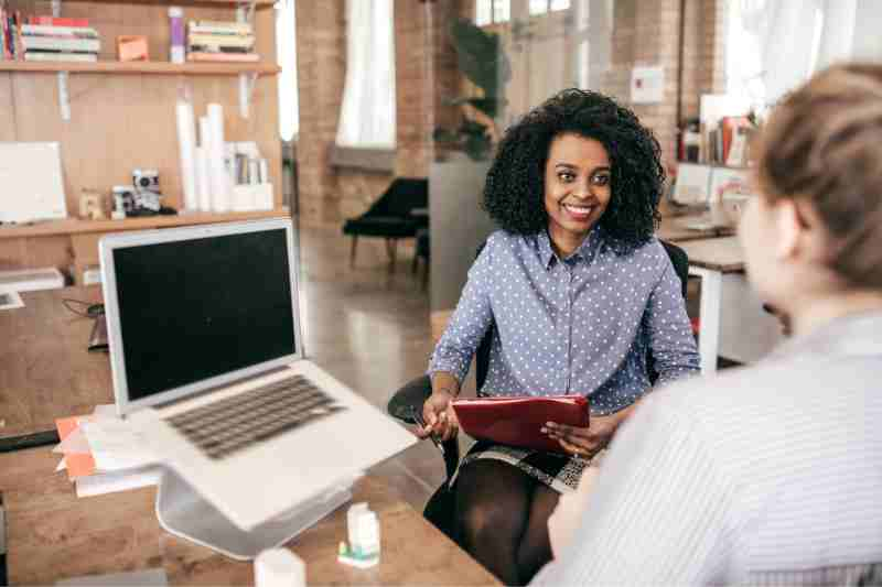 woman at desk hiring a property manager