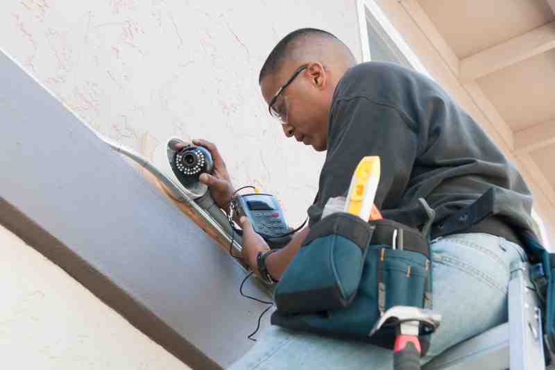 A man carrying out security camera installation.