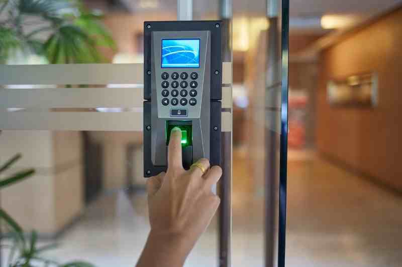 Using a fingerprint access control reader at a door.
