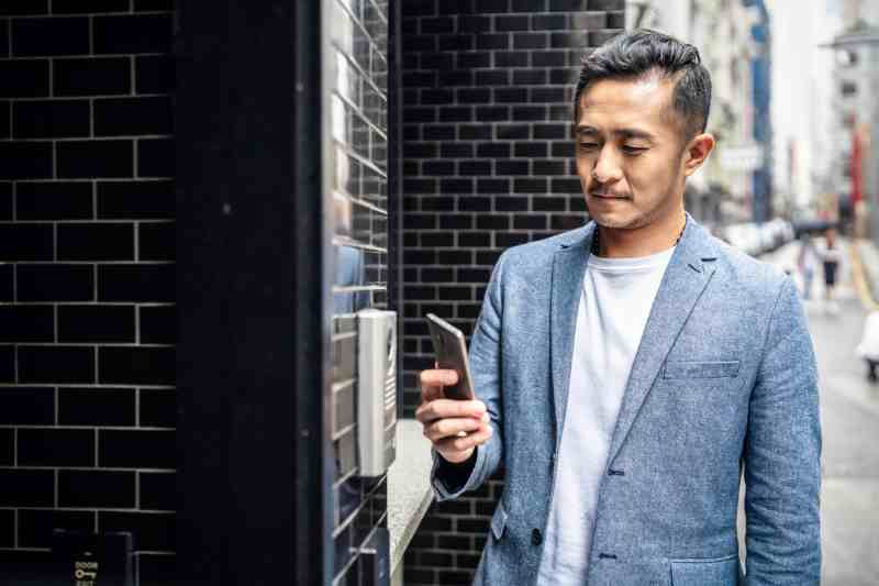 Man unlocking a Bluetooth lock with a smartphone.