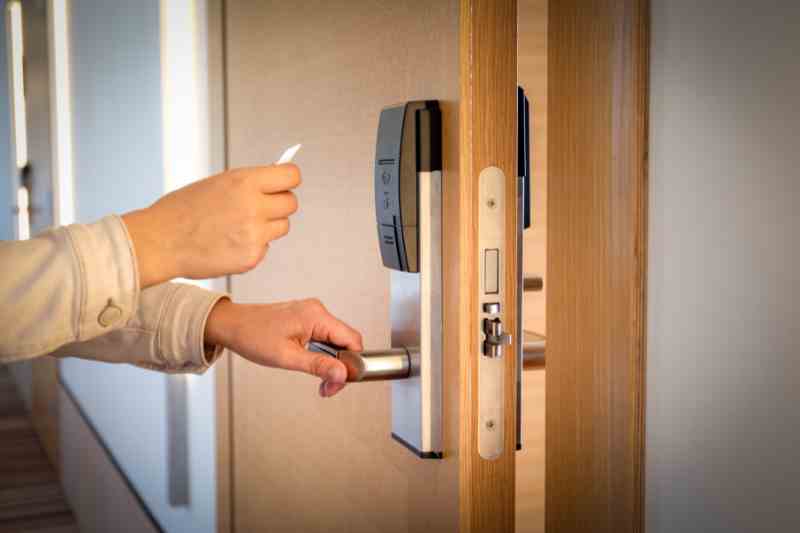 Using a keycard to open a commercial keyless door lock.