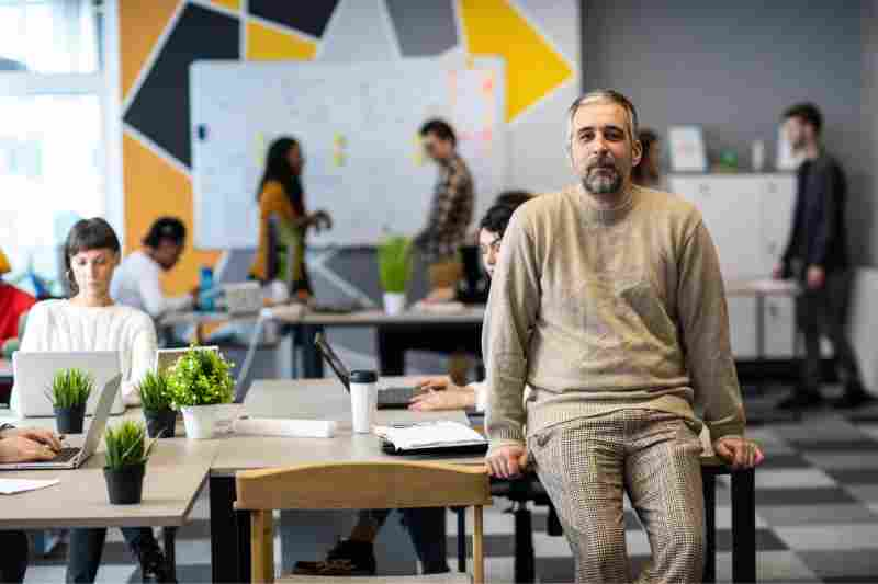 person sitting on desk in apartments with coworking space