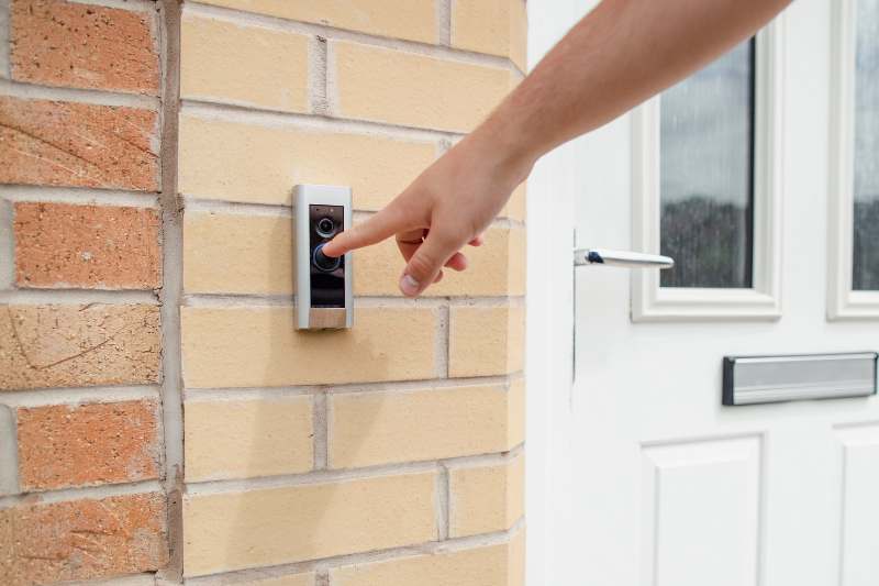 Man ringing a Ring doorbell for apartments