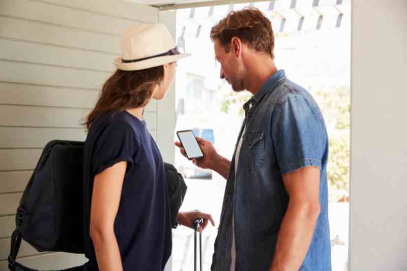 Guests using a visitor sign in app to enter a property.