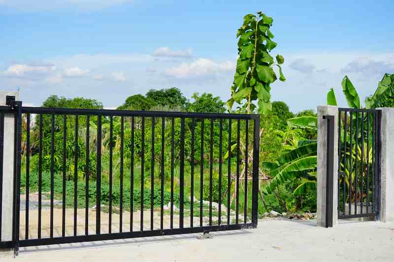 Opening a gate with an automatic sliding gate opener at a gated community.