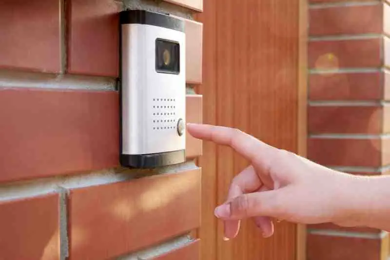 resident using door intercom with camera