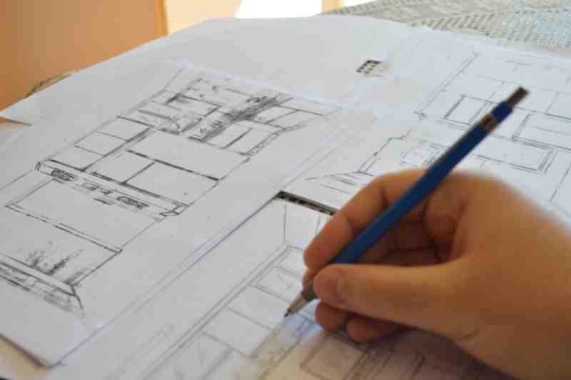 Architect creating multifamily architecture blueprint.