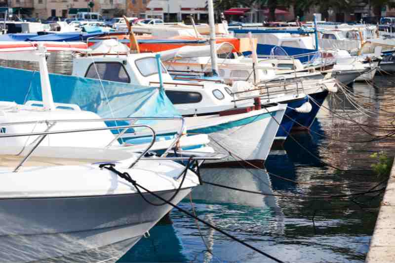 Marina manager docking boats at the harbor.