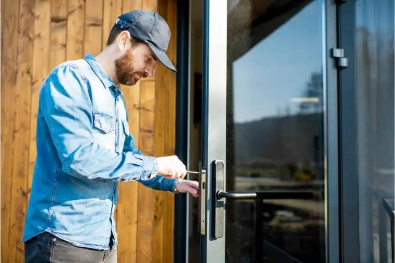 A man fixes a pick proof lock.