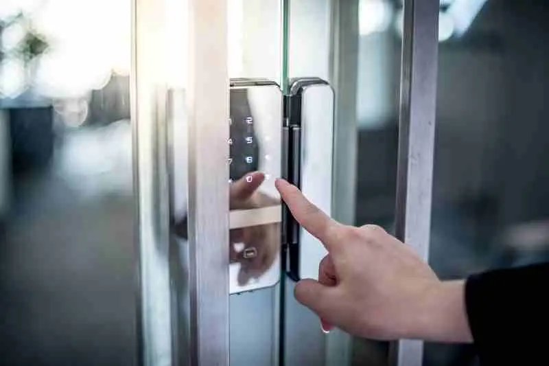 Person using a keypad to open a mantrap door.