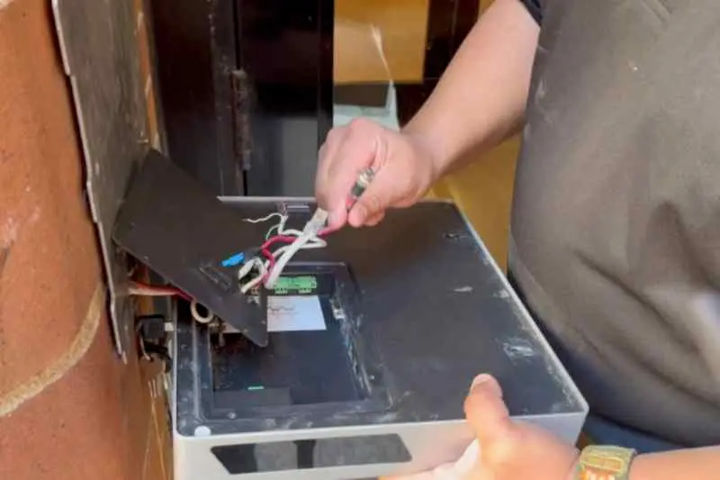 installer removes the I/O port cover and disconnects the wiring