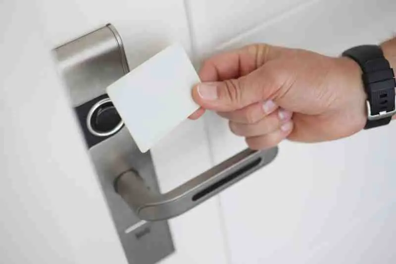 Person using an access card at RFID card reader.