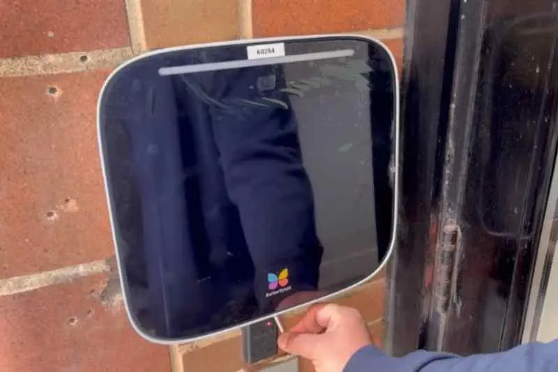 installer secures and locks the new intercom to the backplate